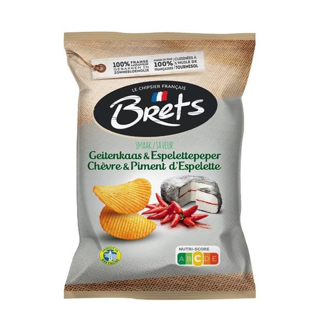 Un paquet blanc et brun avec 2 chips, des petits piments rouges et du fromage de chèvre entier. Le tout sur fond blanc